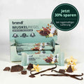 Lightgrün verpackte brandi muskelriegel proteinriegel vanille schokolade mit illustrationen von kakaobohnen und mandeln