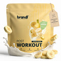 Brandl post-workout vegan 2.0 banane traum cremiges veganes proteinpulver in goldgelbem beutel mit bananen- und milchspritzern