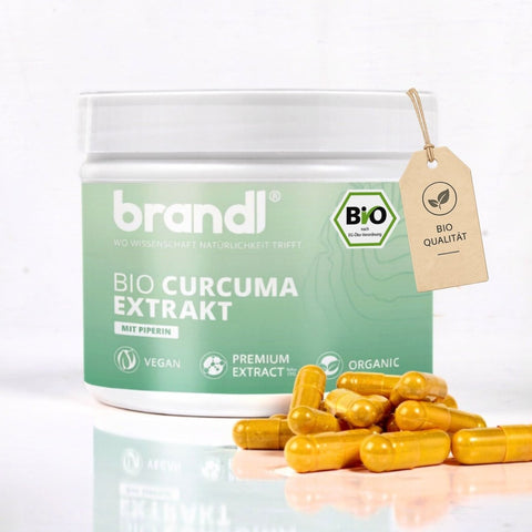 Brandl bio curcuma extrakt in einem durchscheinend grünen glas mit goldenen kapseln für natürliche gesundheitsförderung