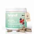 Weißer zylinderförmiger container mit brandl bio opc plus vitamin c kapseln und minzgrünem etikett mit beerenbildern