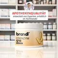 Brandi coenzym q10 kapseln in weißem zylinder mit orangefarbenem etikett und goldenen kapselbildern