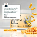 Ein weißer zylinderförmiger behälter mit beigem etikett coenzym q10 kapseln und 23g ubiquinol umgeben von goldgelben kapseln