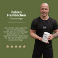 Weisser zylinderförmiger behälter mit grünem und schwarzem branding des produkts pure greens superfoods pulver